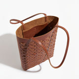 Brown leather weave tote bag with woven pattern on a white background