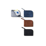 Four different colored compact wallets on a white background