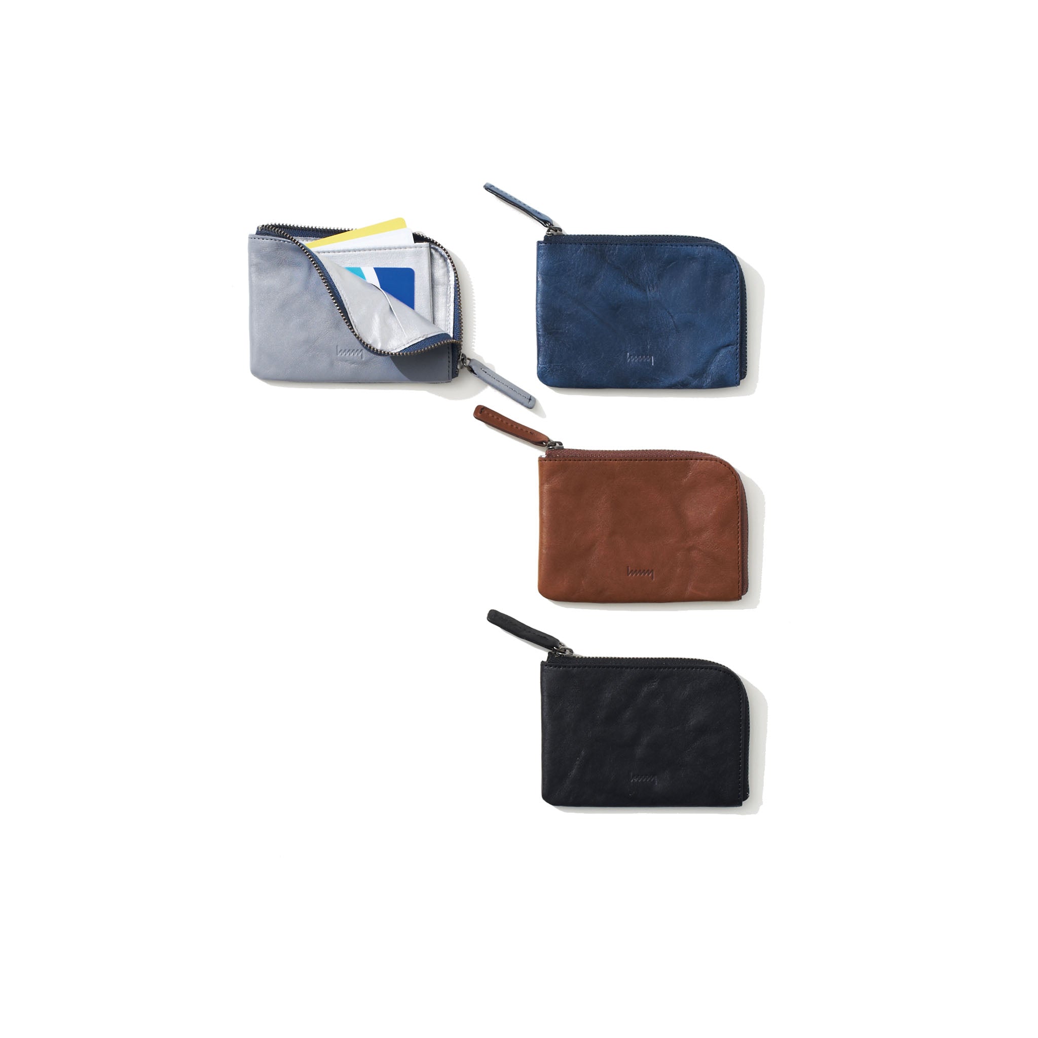Four different colored compact wallets on a white background