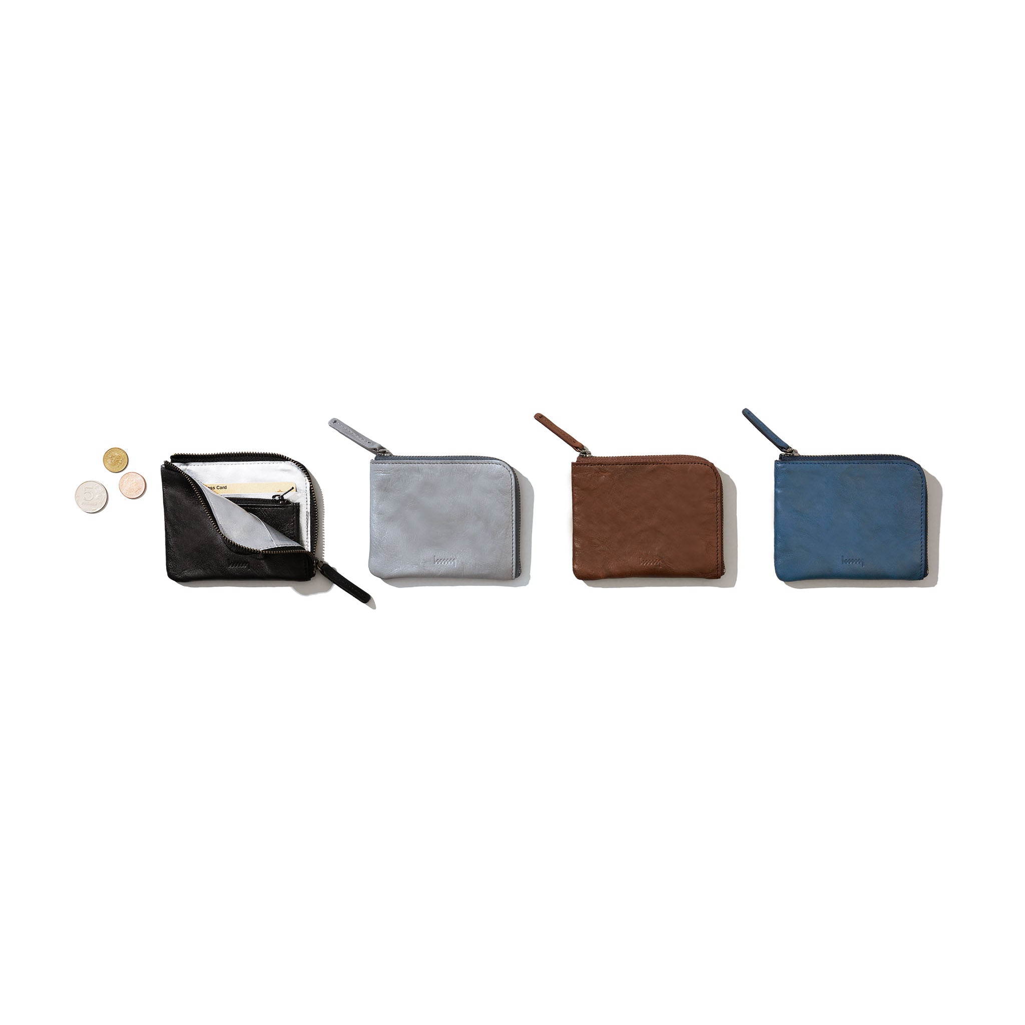 Four different colored compact wallets on a white background