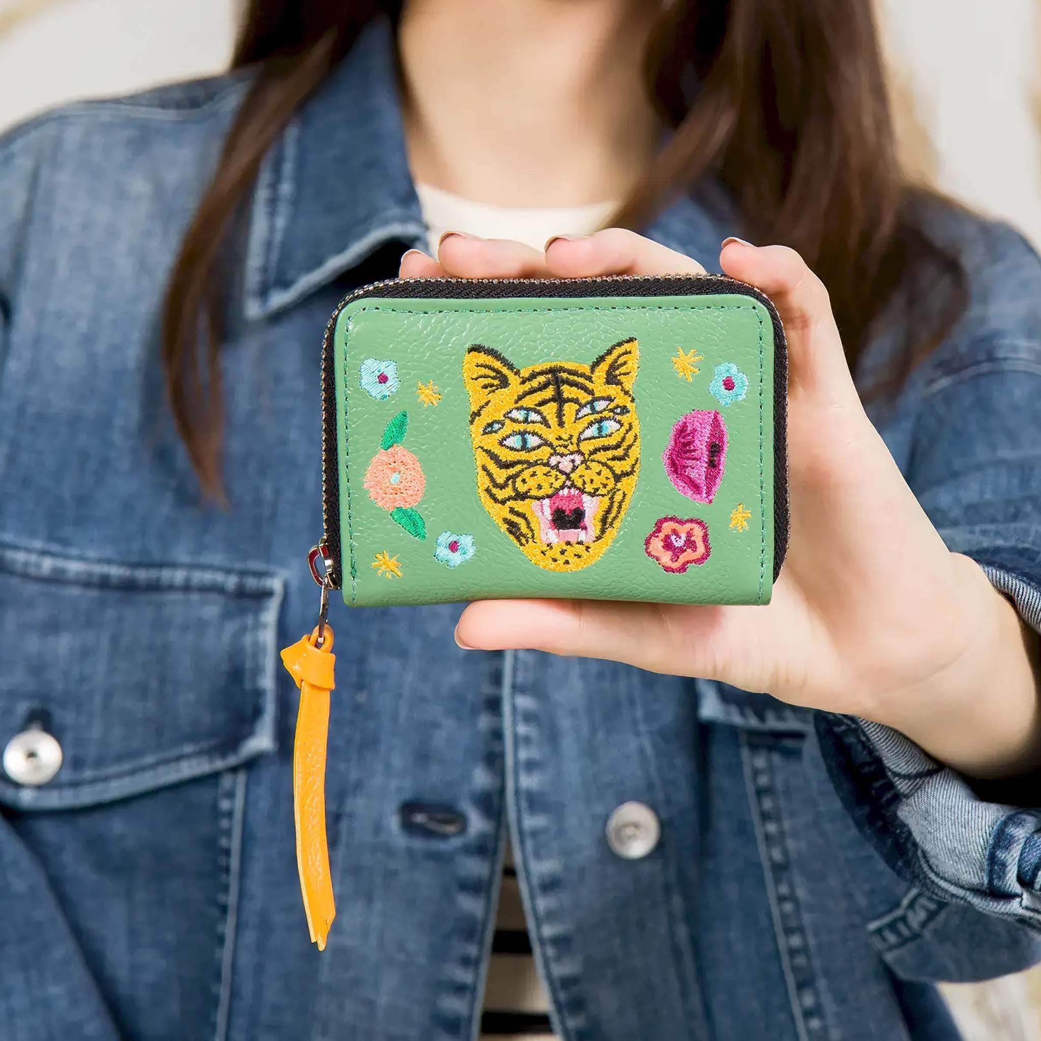 Person holding Min & Mon's Frodo Basil Green Leather Zip Around Wallet - Happy Tiger Embroidery