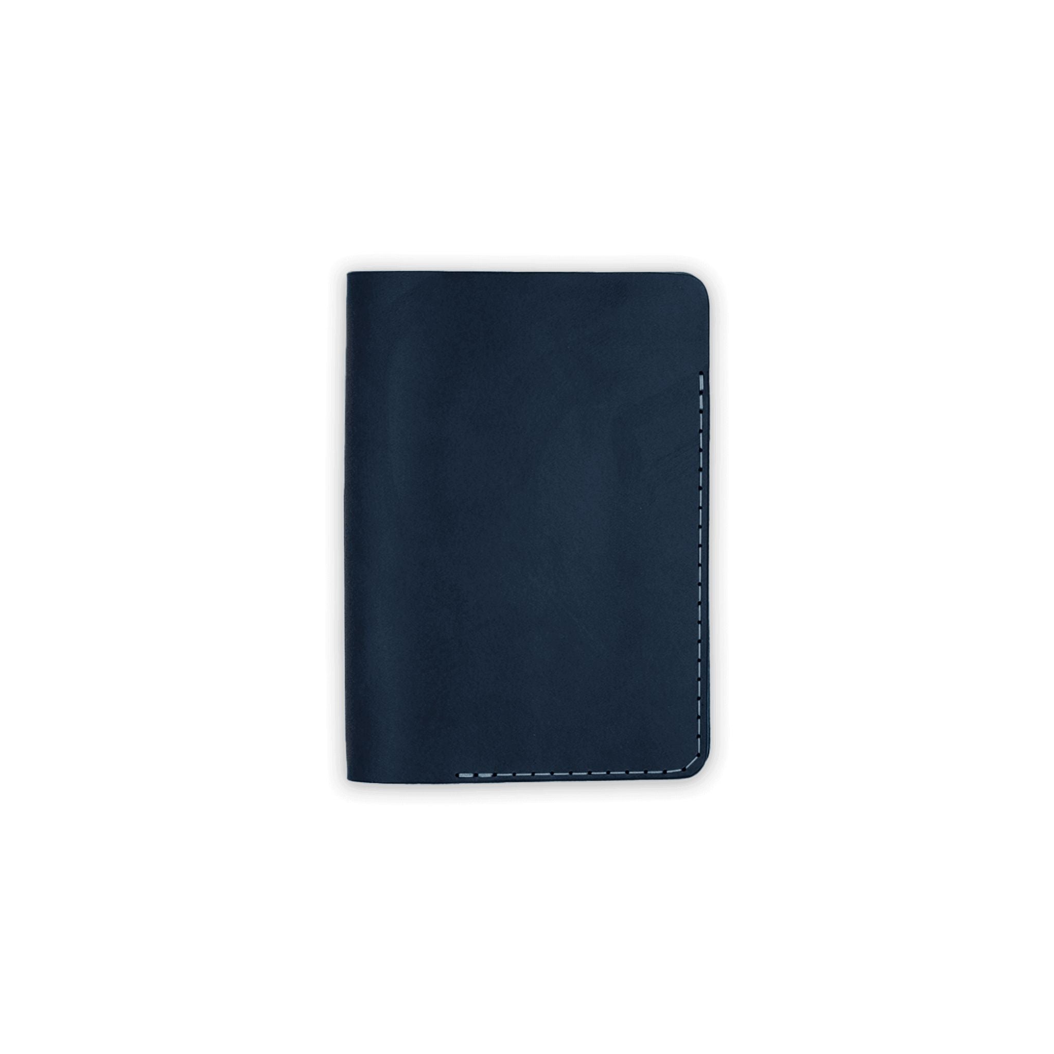 Navy blue leather passport cover on a white background