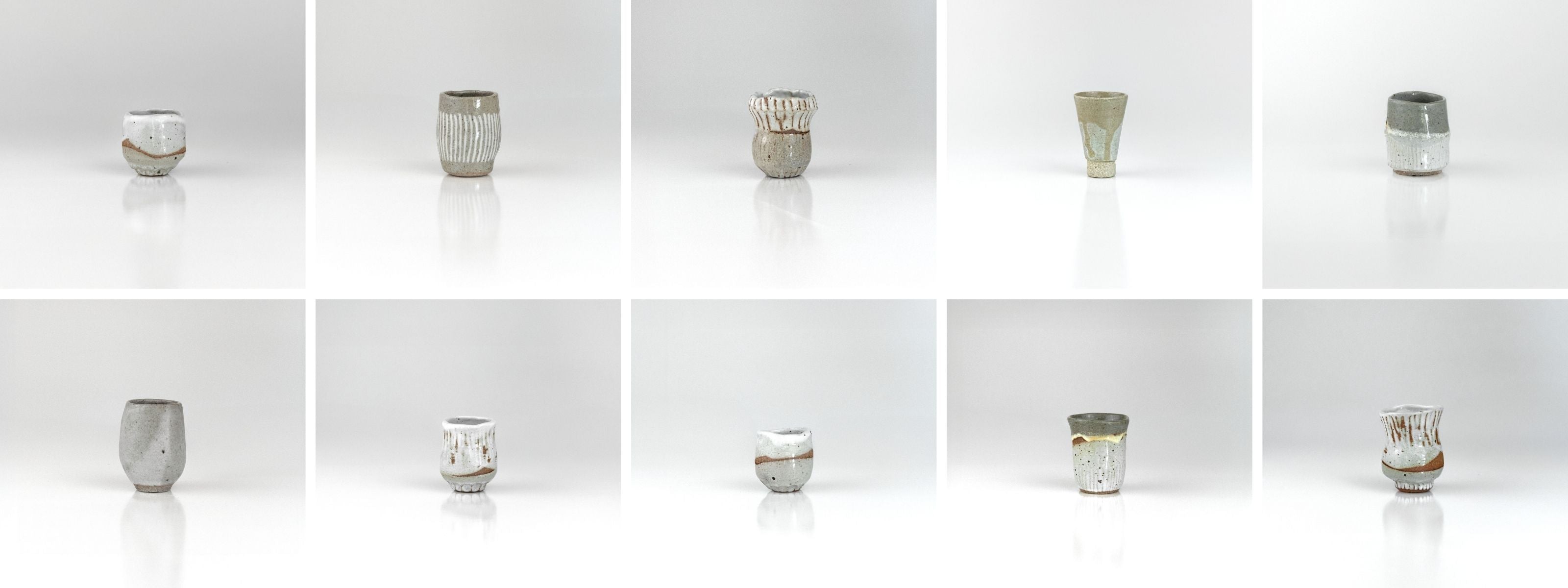 Ten one-of-a-kind ceramic sake cups by The Lazy Potters, each uniquely shaped and glazed in shades of white, grey, and earthy clay, displayed in a clean grid layout on a reflective white surface.