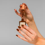 Image of model's hands whose wearing BKIND vegan nail polish color Chai