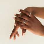 Image of model's hands whose wearing BKIND vegan nail polish color French Pink