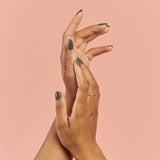 Image of model's hands whose wearing BKIND vegan nail polish color La Route Verte