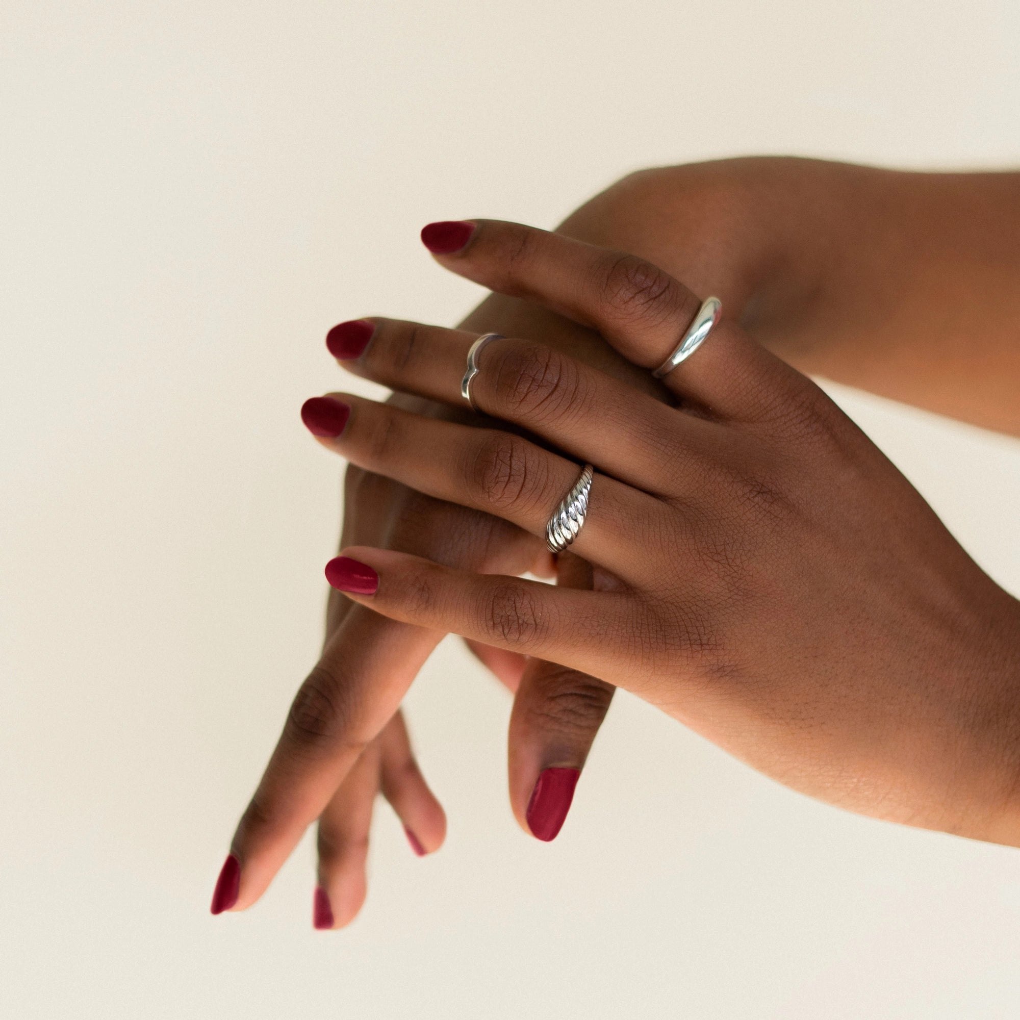 Image of model's hands whose wearing BKIND vegan nail polish color Scorpio