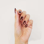 Image of model's hands whose wearing BKIND vegan nail polish color Une Cenne