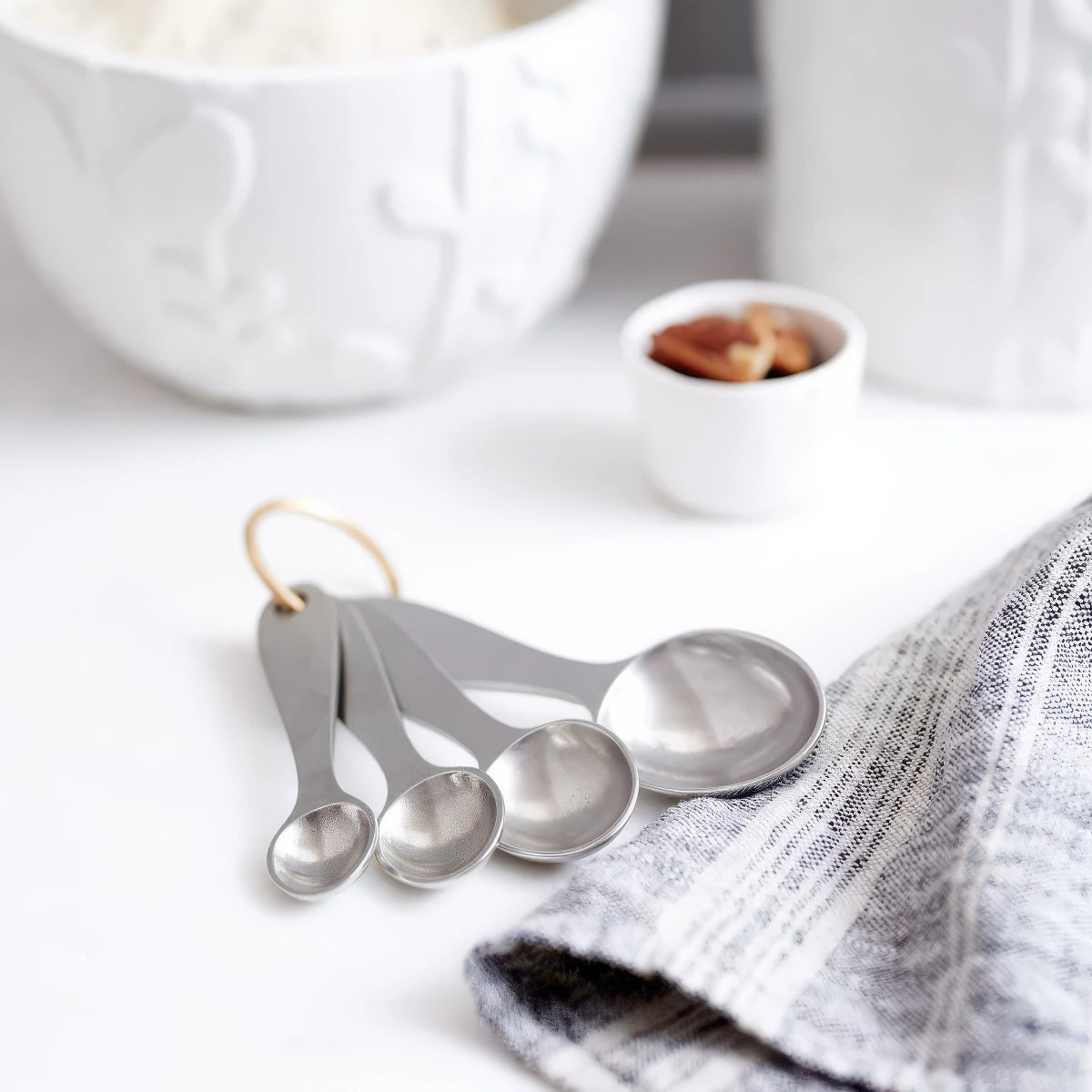 lifestyle image of beehive pewter measuring spoon set