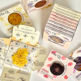 Collection of 'The Qi' product packages with various herbs and packaging designs.