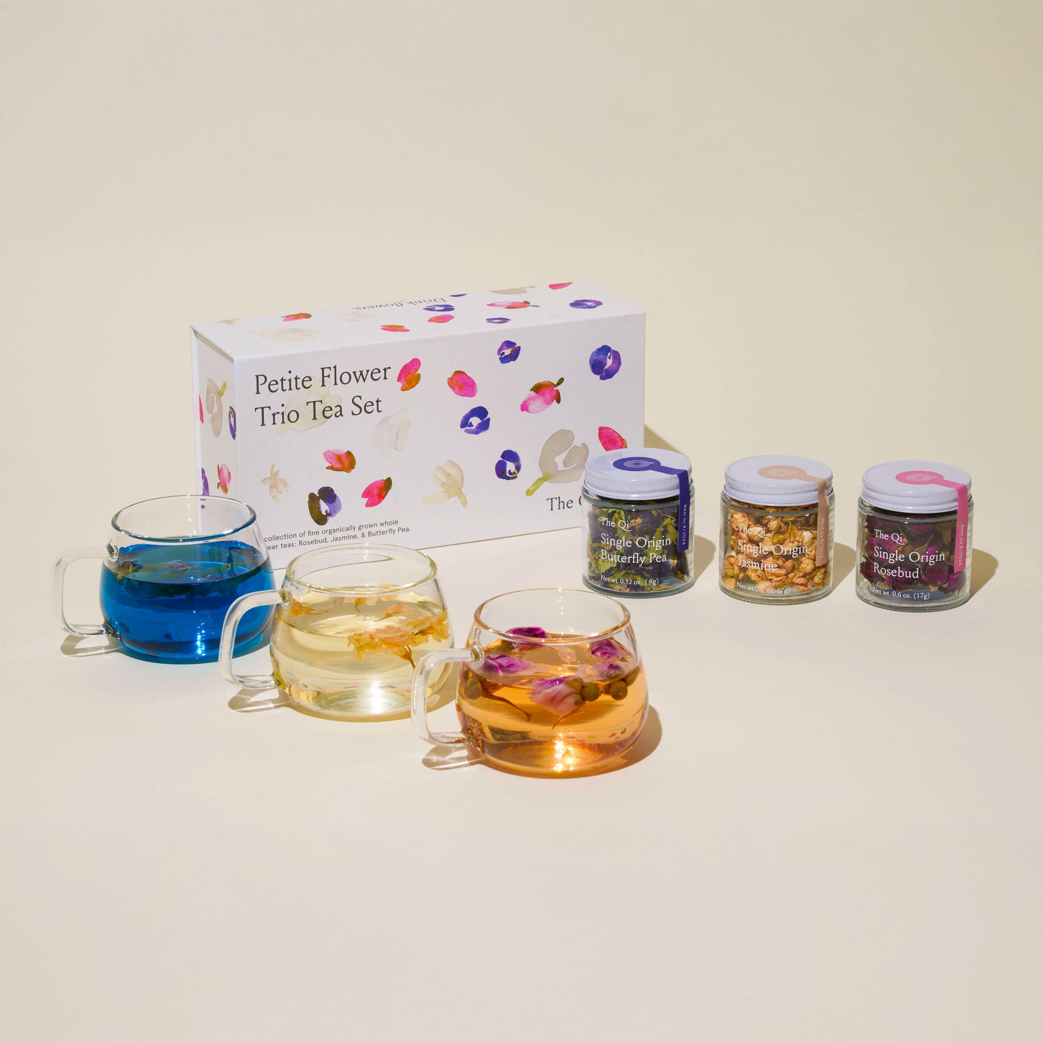 Petite Flower Trio Tea Set with three glass cups and three small jars on a beige background