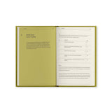 Open notebook with green cover and white pages on a white background