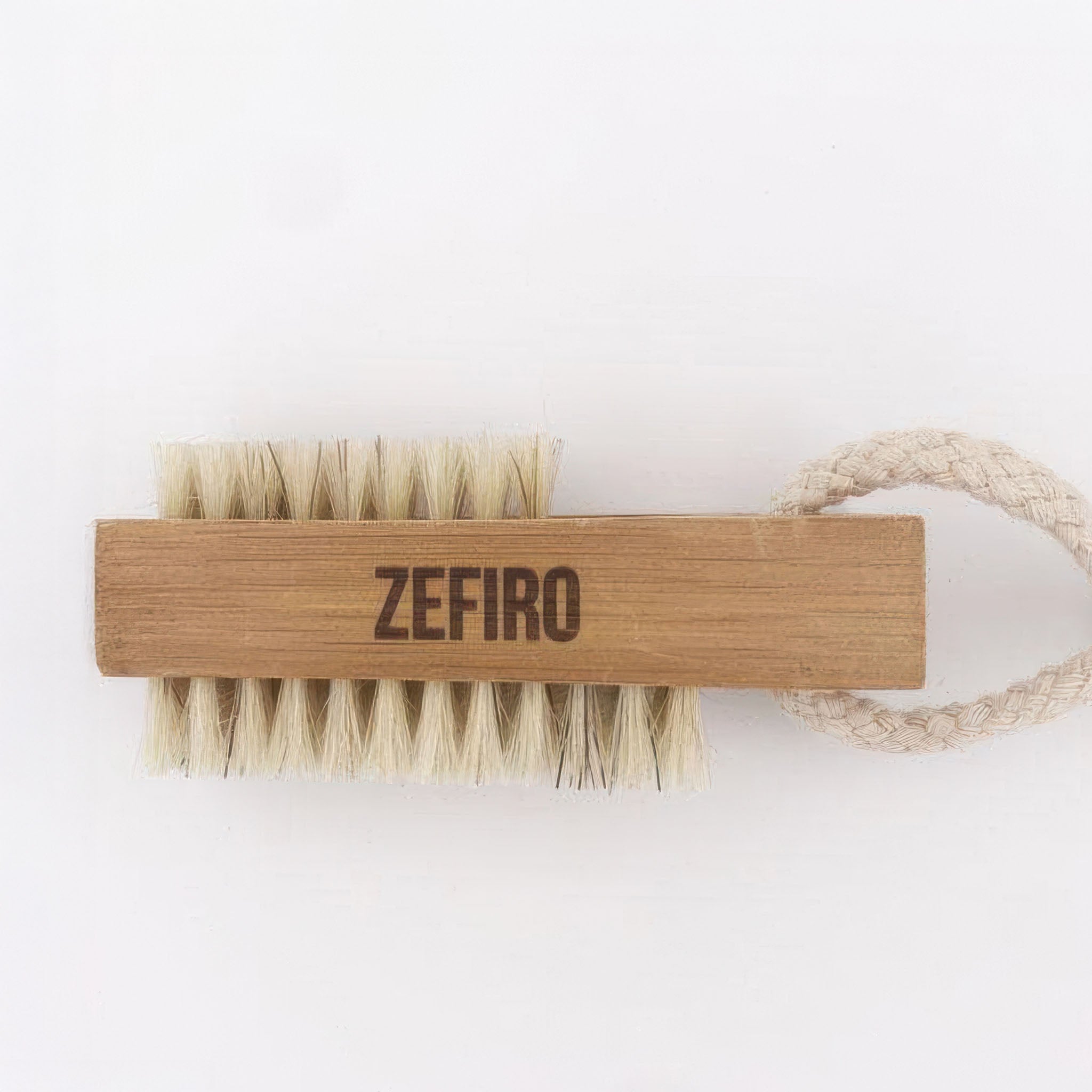 Wooden nail brush with bristles and 'Zefiro' branding on a white background