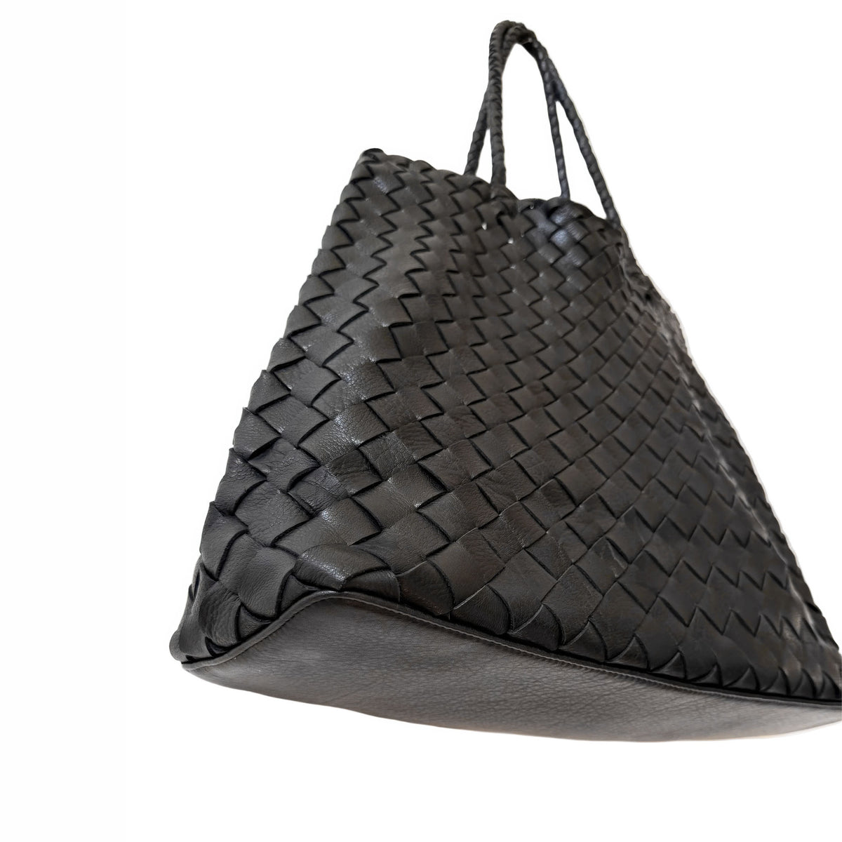 A black woven leather tote bag with a textured basketweave pattern and dual top handles, shown against a plain white background.
