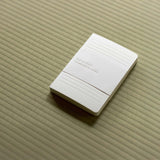 White iA notebook for writers on a textured tatami surface.