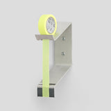 Multi Radius Tape Dispenser mounted to a white wall holding a roll of yellow tape