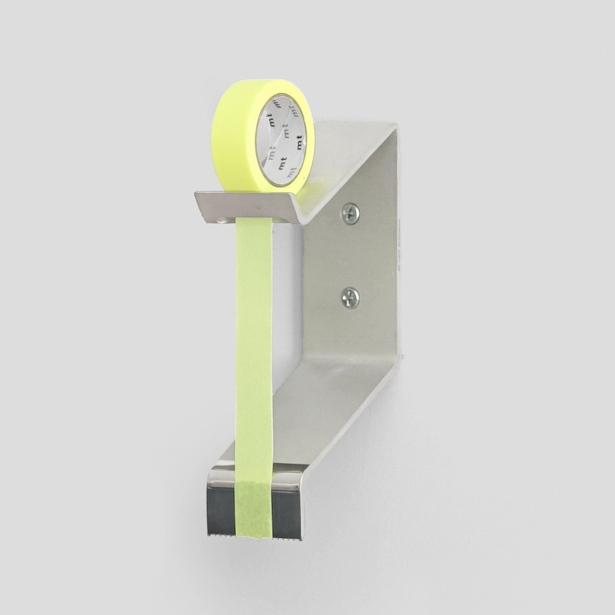 Multi Radius Tape Dispenser mounted to a white wall holding a roll of yellow tape