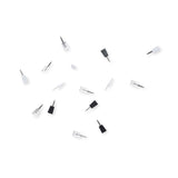 A collection of white, clear and black ninja mini pins scattered on a white background