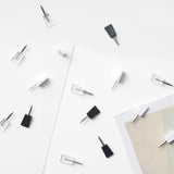 Aesthetic image of a collection of ninja mini pins scattered across various types of paper