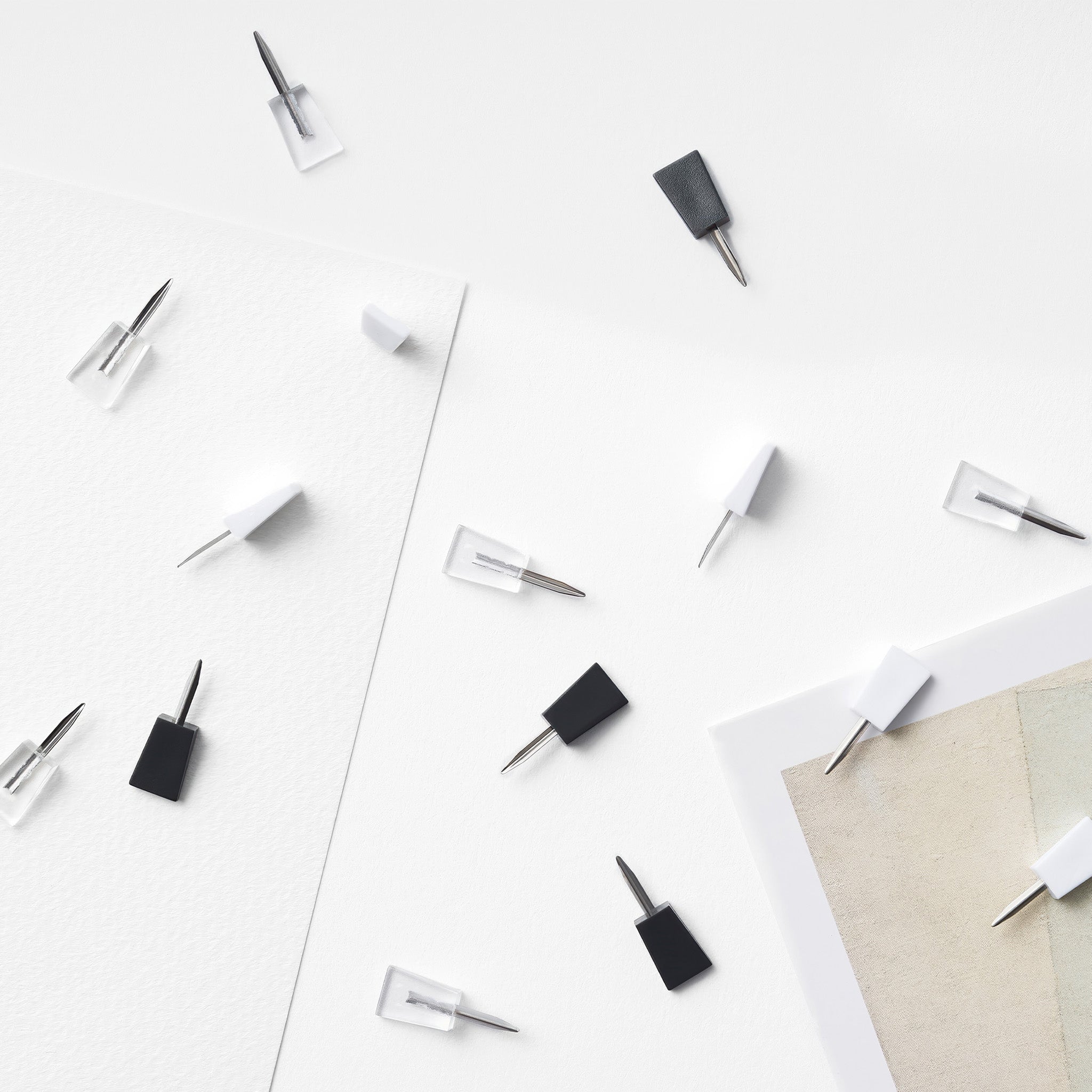 Aesthetic image of a collection of ninja mini pins scattered across various types of paper