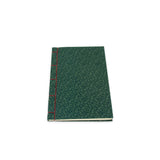 Green notebook with red spine on a white background