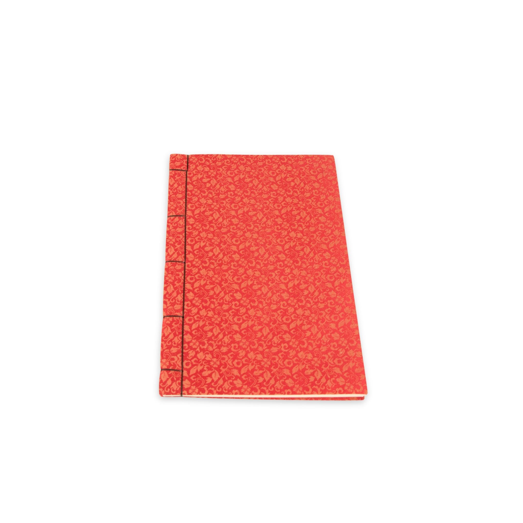 Red notebook with a textured cover on a white background