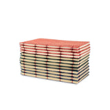 Stack of red, green and blue notebooks  on a white background