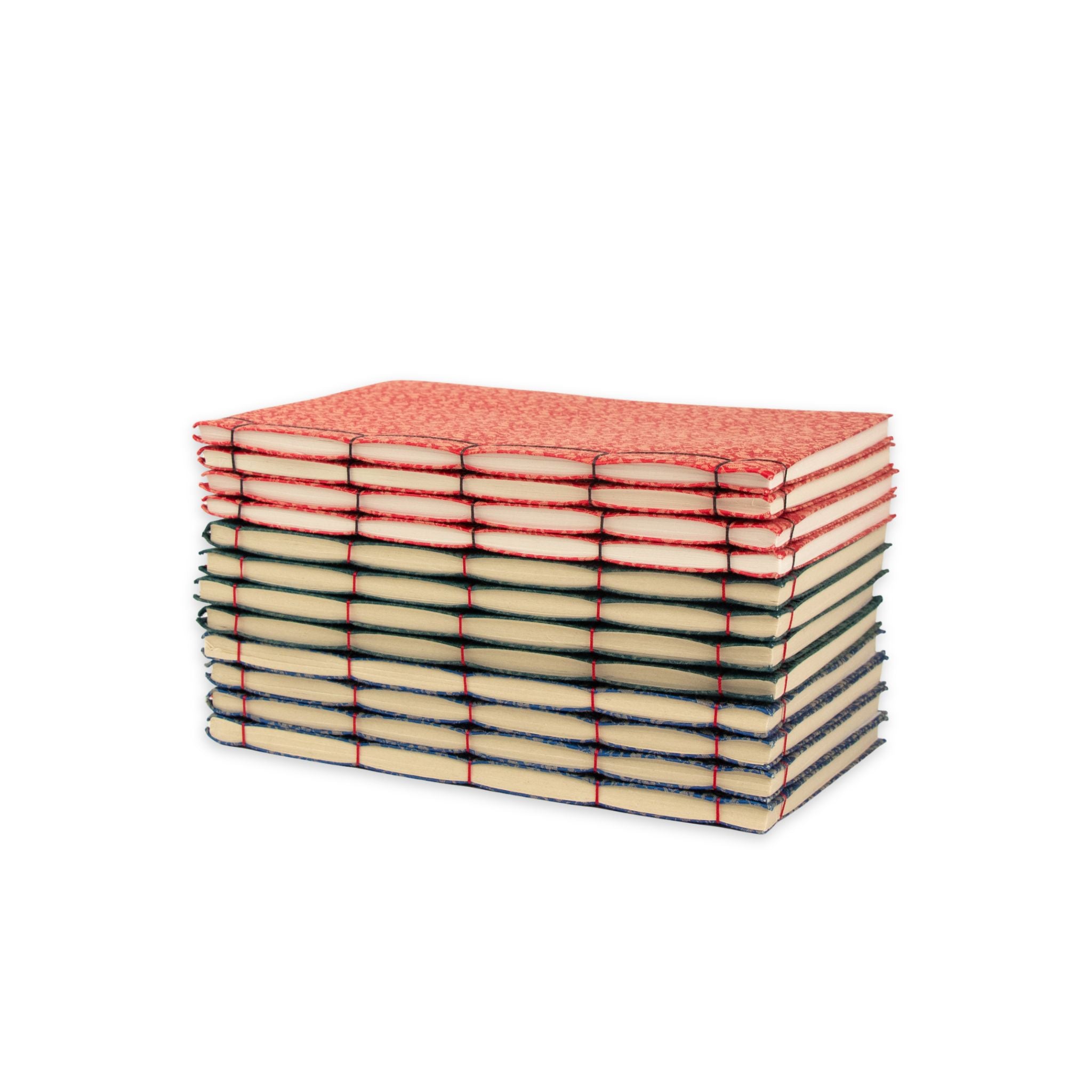 Stack of red, green and blue notebooks  on a white background