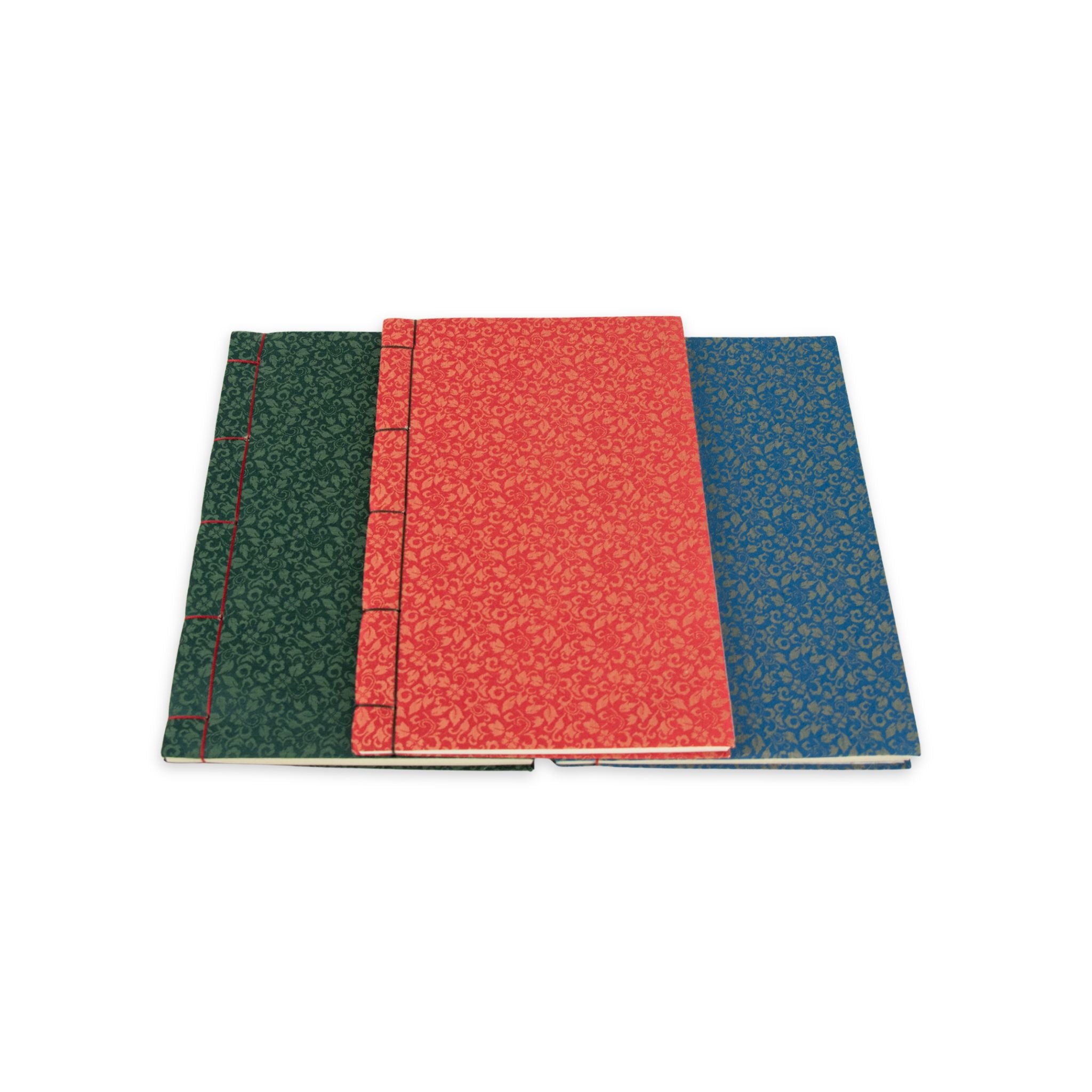 Three notebooks with different colored covers on a white background