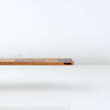 Wooden De Stilj ruler with MoMA logo on a white background