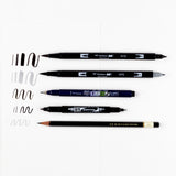 Set of Tombow dual-tip markers on a white background with sample strokes.