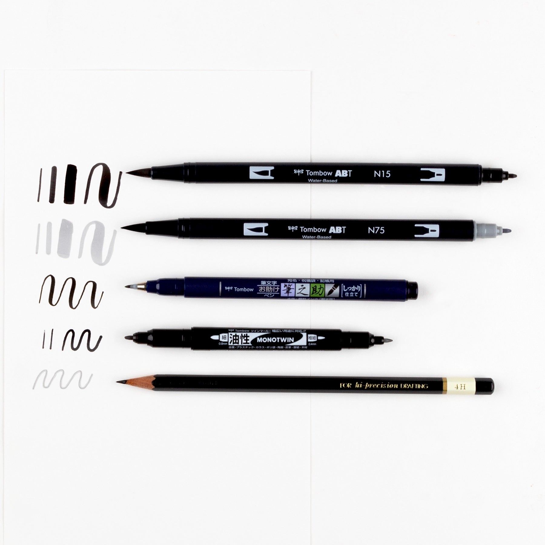 Set of Tombow dual-tip markers on a white background with sample strokes.