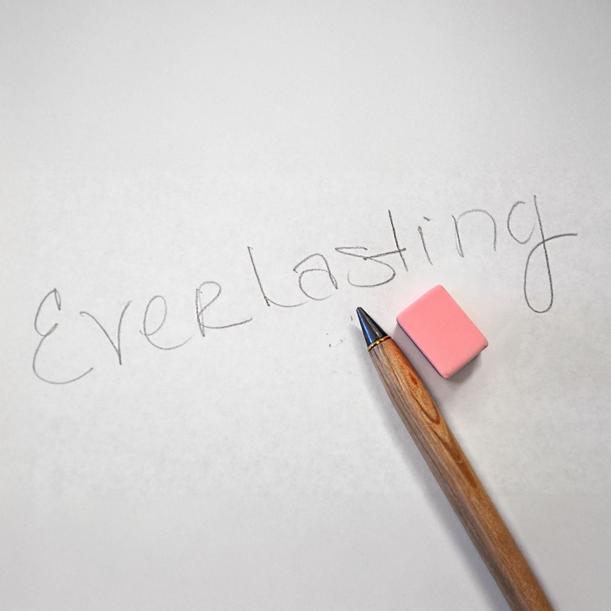 Pencil and eraser on paper with the word 'Everlasting' written.