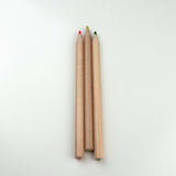 Three highlighter pencils with wooden bodies and colorful tips on a white background