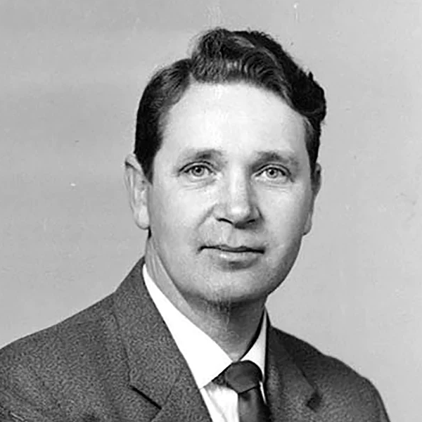Black and white portrait of Arne Clausen  in formal attire against a plain background