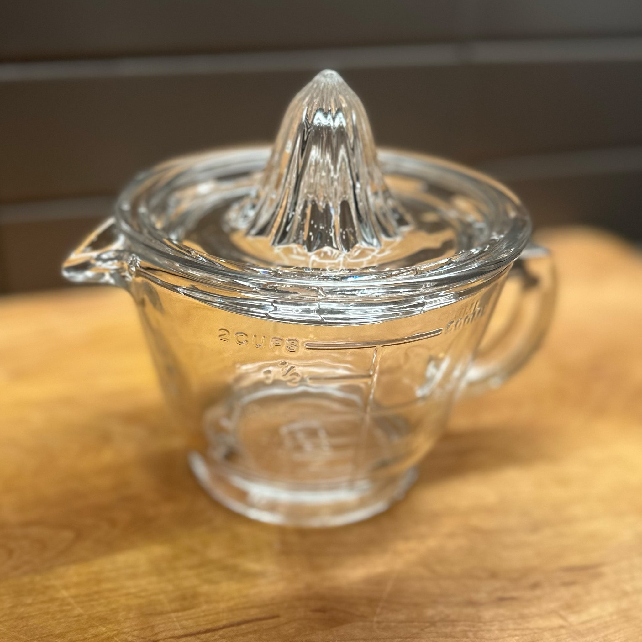 Side view of IEarth & Nest's Citrus juicer on a wooden table top