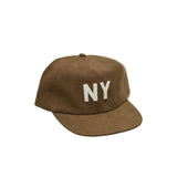 Front angled view of the linen NY hat in brown