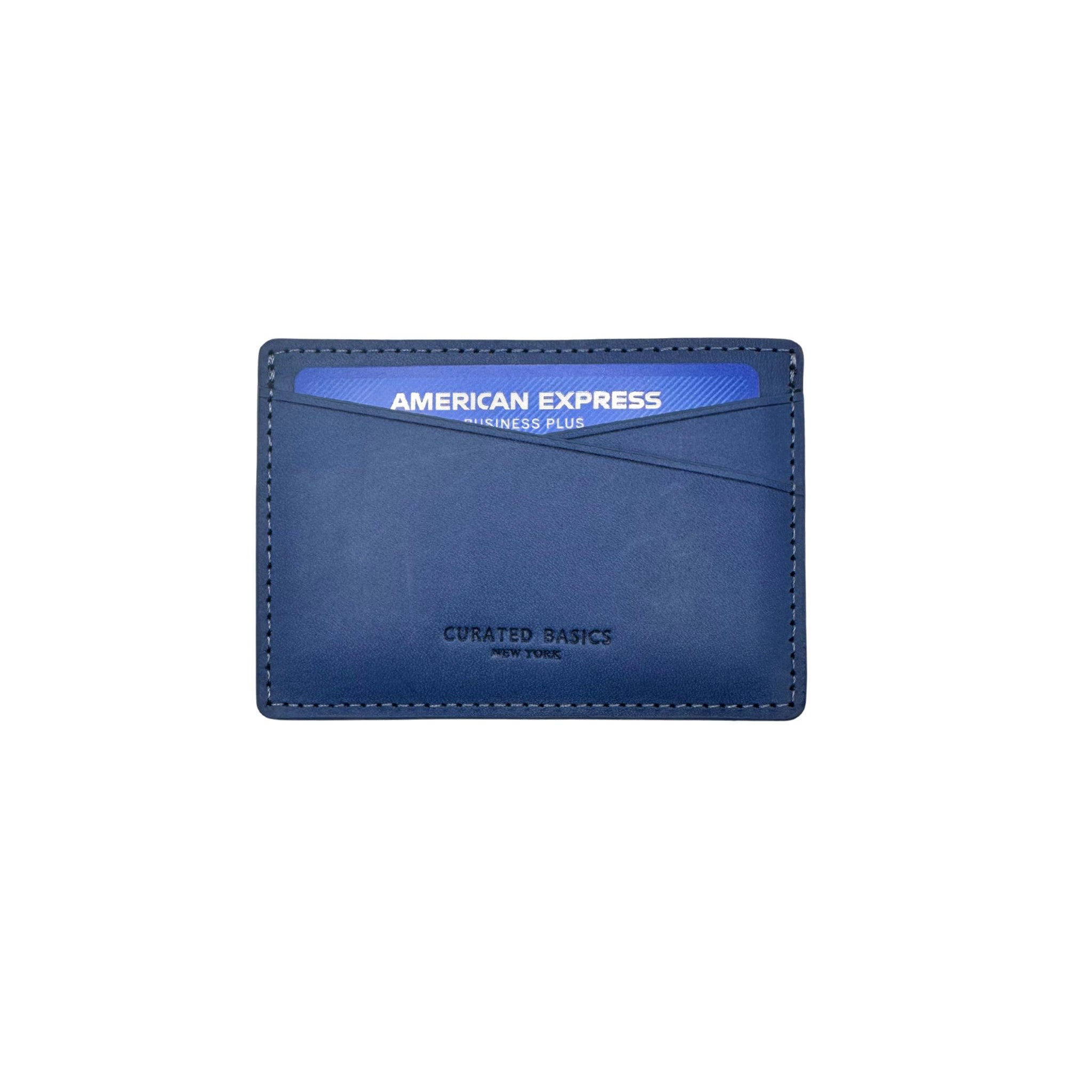 Front image of the navy leather card holder by Curated Basics holding an American Express credit card