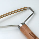 Close up of the Beechwood stainless steel and copper lint remover