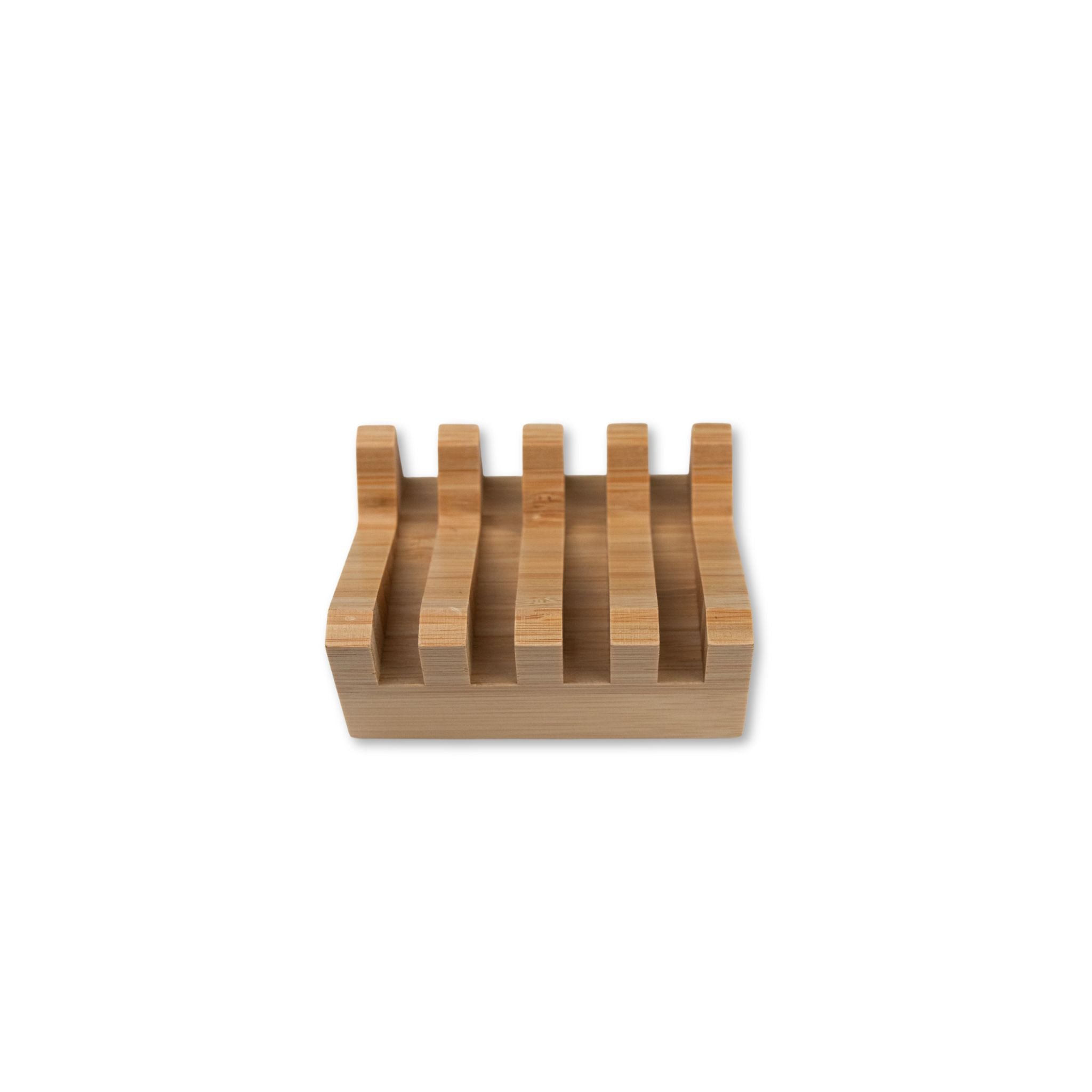 Slanted wooden soap dish on a white background