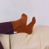 Arctic Fox's cosy recycled socks in sepia on a light-colored surface