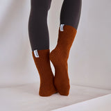 Arctic Fox's cosy recycled socks in sepia on a light-colored surface