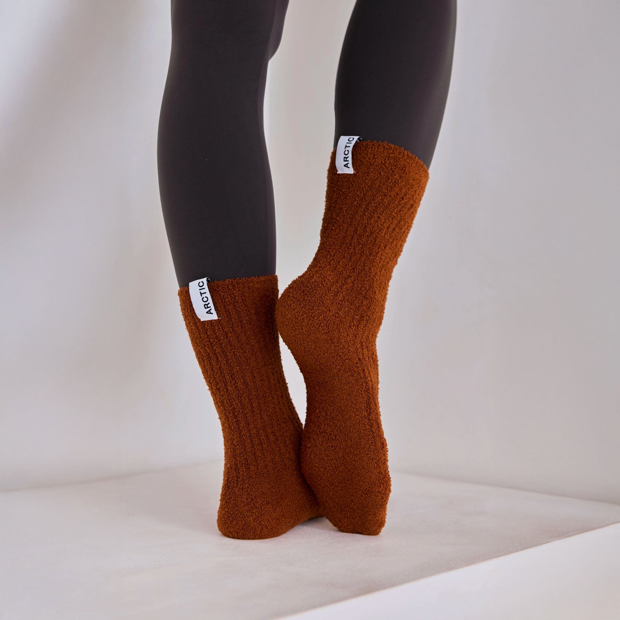 Arctic Fox's cosy recycled socks in sepia on a light-colored surface