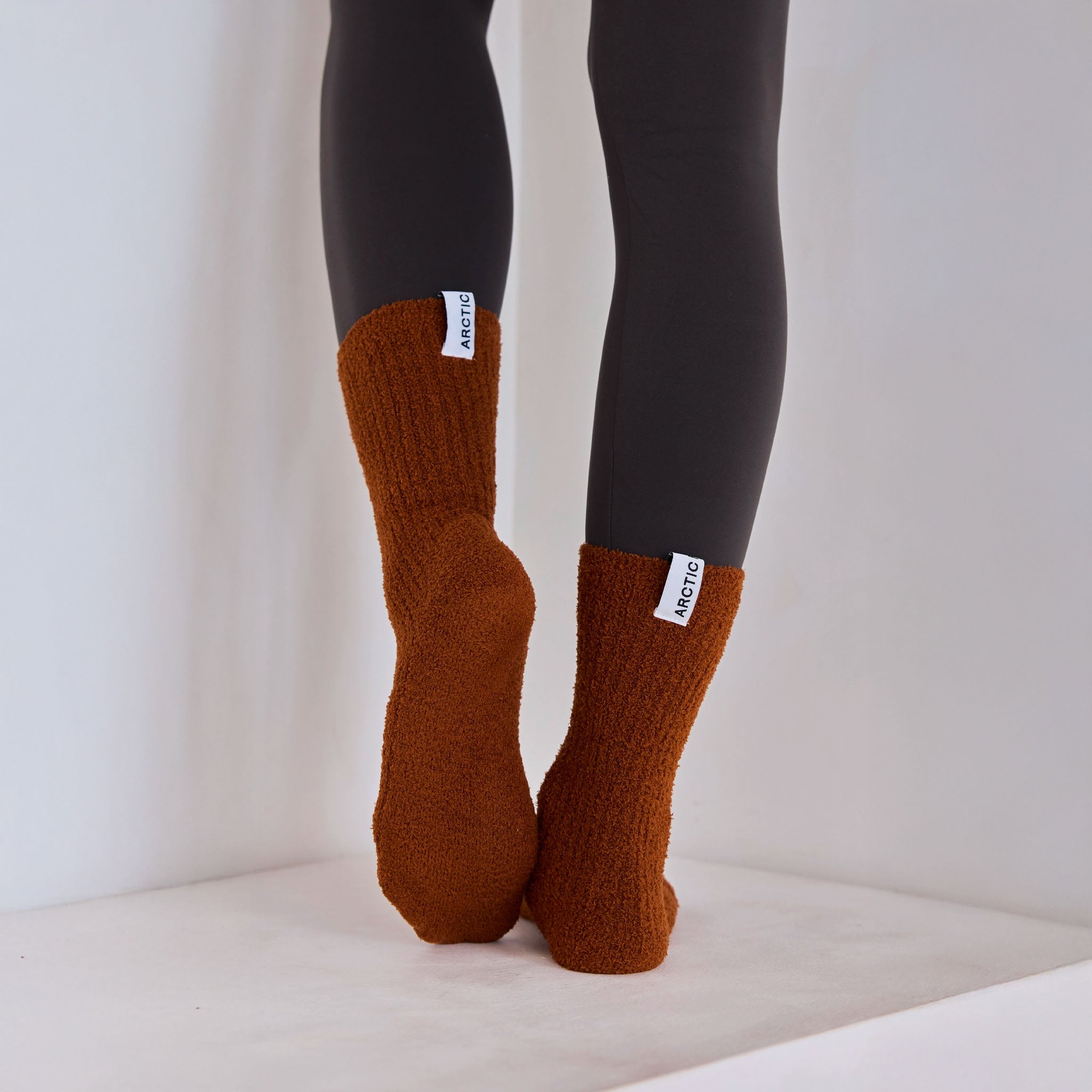 Arctic Fox's cosy recycled socks in sepia on a light-colored surface