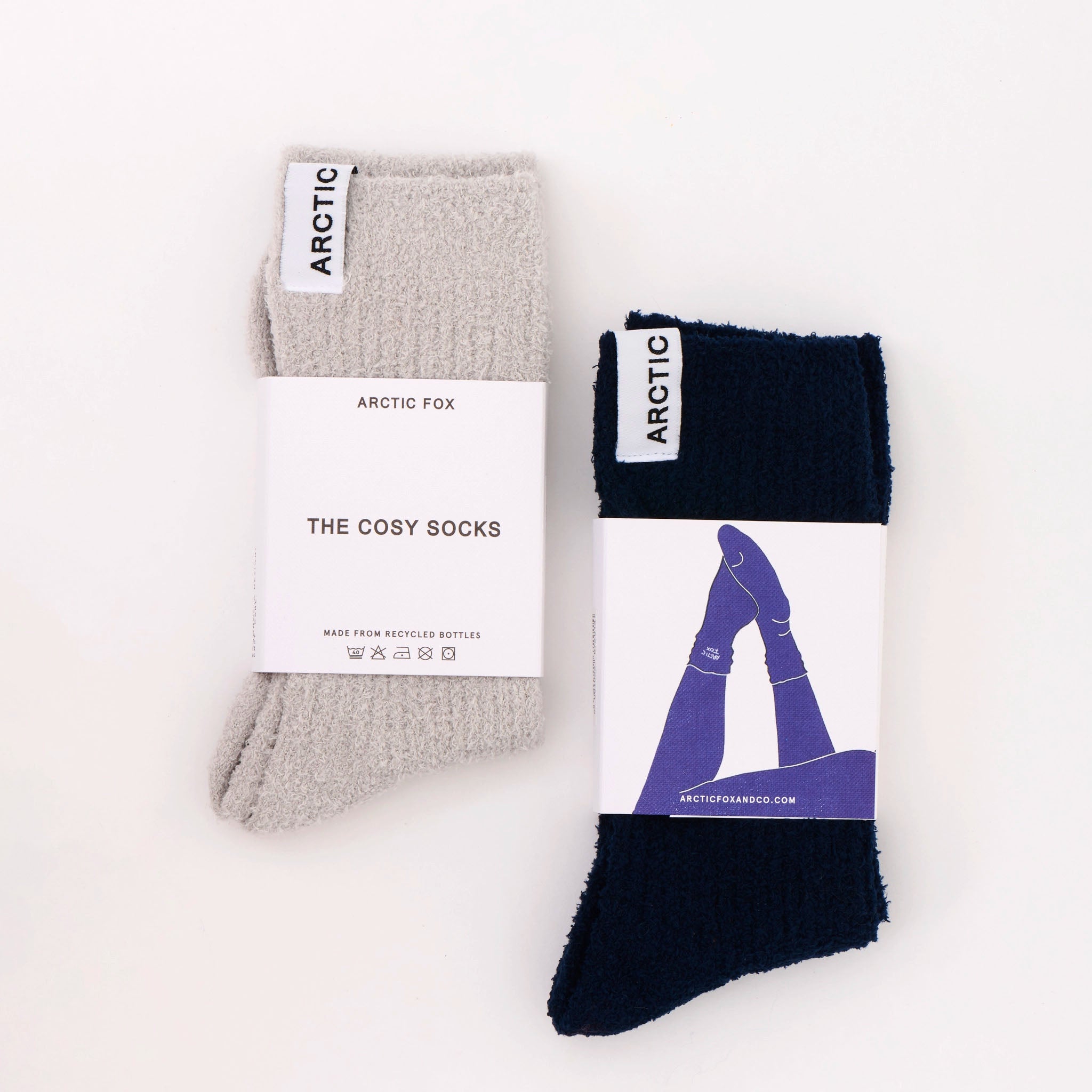 Two pairs of socks with packaging on a white background