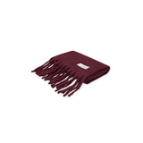 A folded burgundy scarf with fringes on a white background