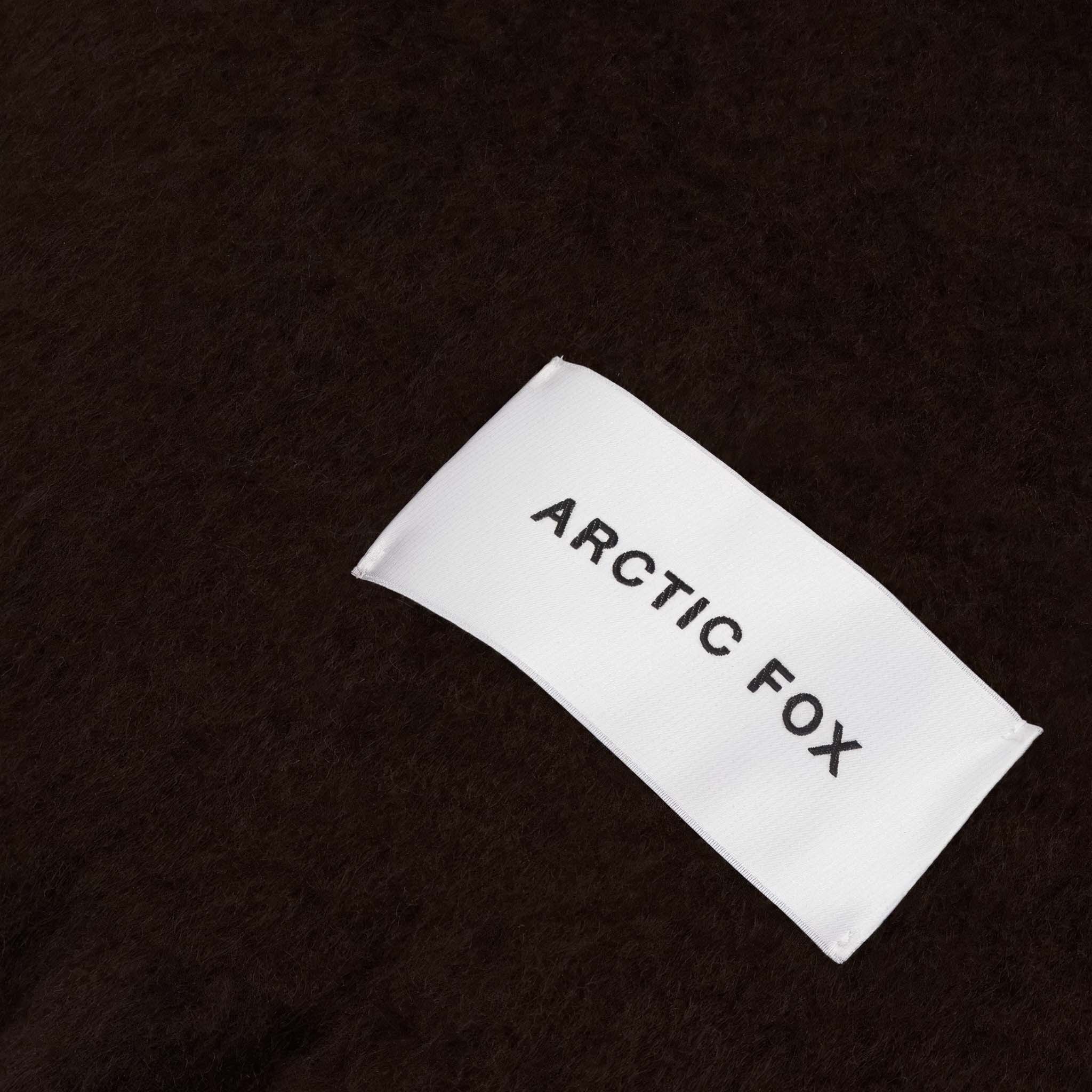 Close up of brown scarf with a brand label Arctic Fox 