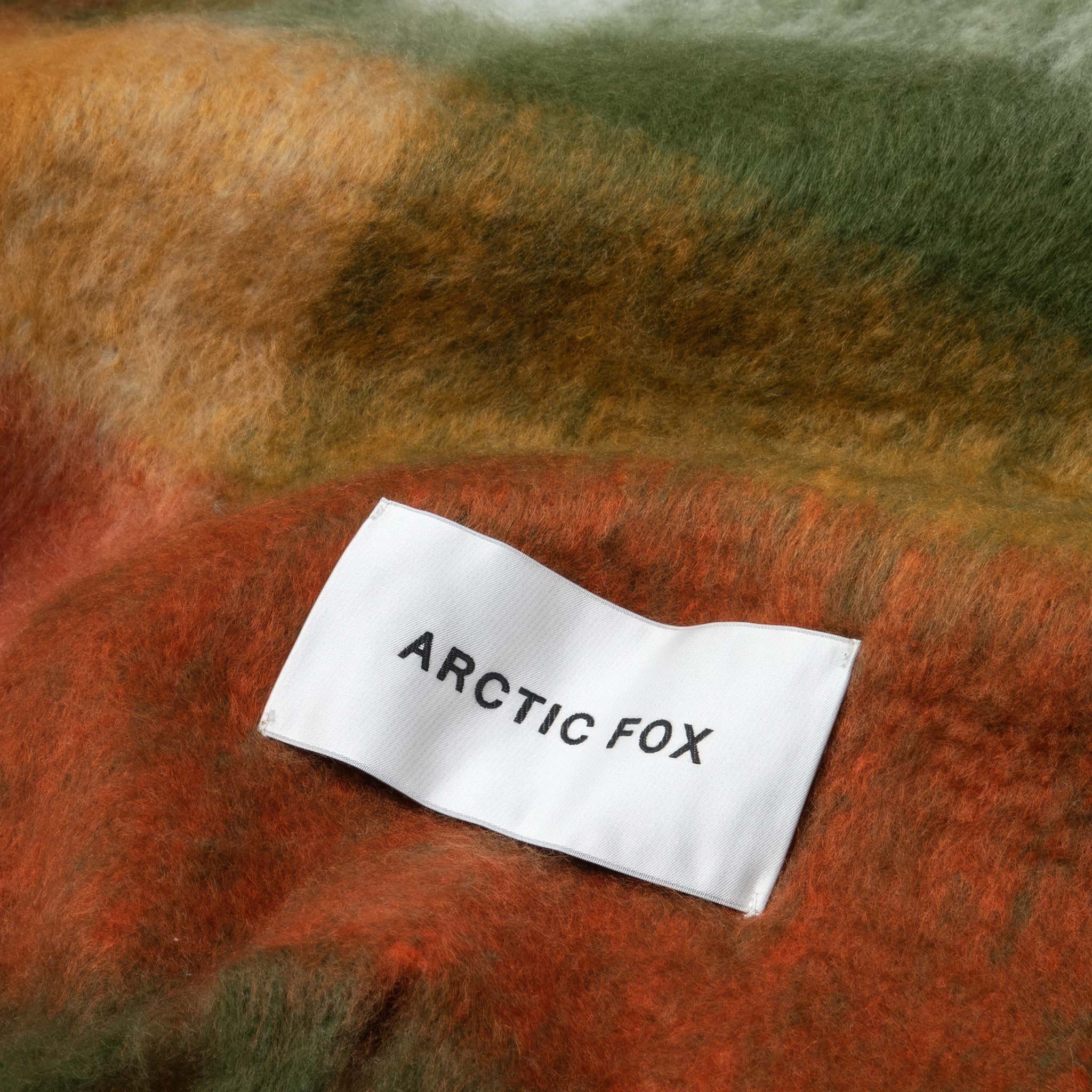 Close up of a multicolor scarf with Arctic Fox label