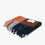 Folded multicolor plaid scarf with fringes and brand label Arctic Fox on a white background