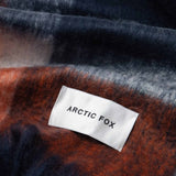 Close-up of the multicolor plaid scarf and brand label Arctic Fox